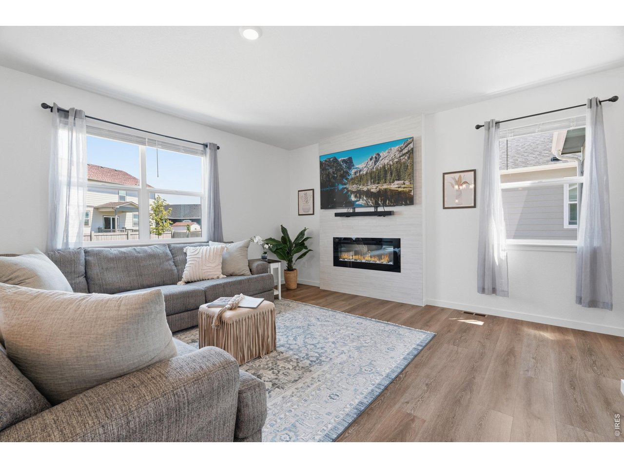 Property Photo 11 Cozy great room anchored by a modern tiled gas fireplace and abundant natural light.
