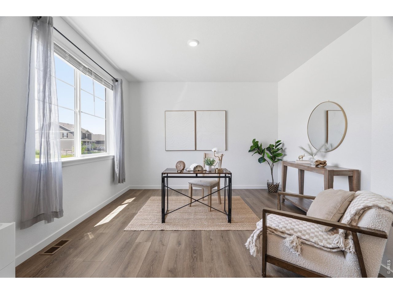 Property Photo 13 Versatile main-floor flex space ideal for a home office, playroom, or formal sitting room.