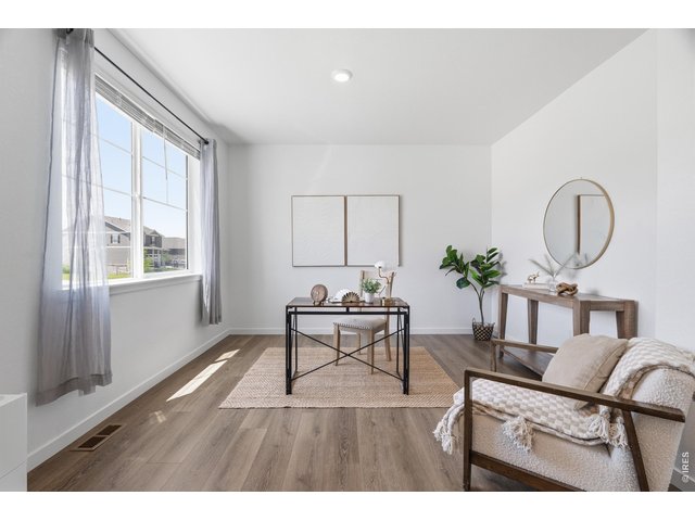 Property Photo 13 Versatile main-floor flex space ideal for a home office, playroom, or formal sitting room.