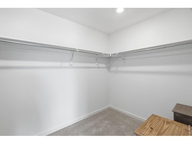 Property Photo 22 Spacious primary walk-in closet with double-hung rods and plenty of room for two.