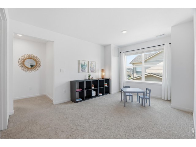 Property Photo 23 Versatile upstairs loft offers bonus living space for a playroom, media area, or second family room.