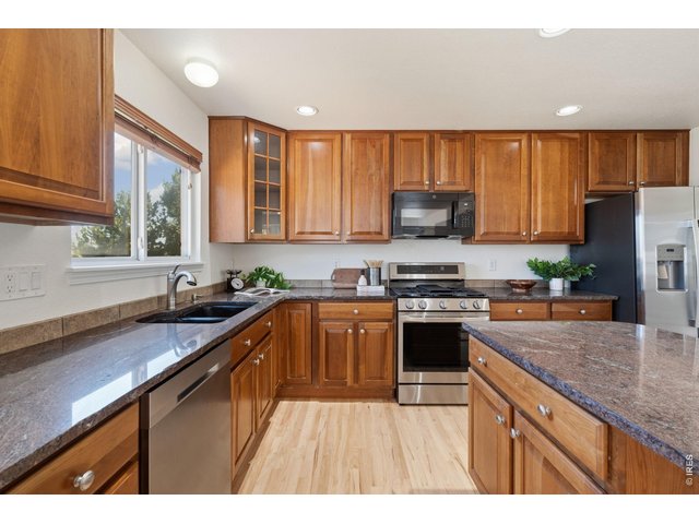 Property Photo 14 Natural wood floors, cabinets, and granite