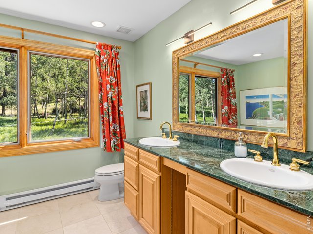 Property Photo 18 Double sinks and rainforest granite in primary bath