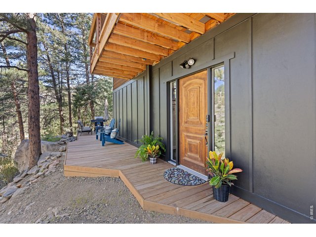 Property Photo 3 Distinctive wood entry door with full-length sidelights welcomes you home.