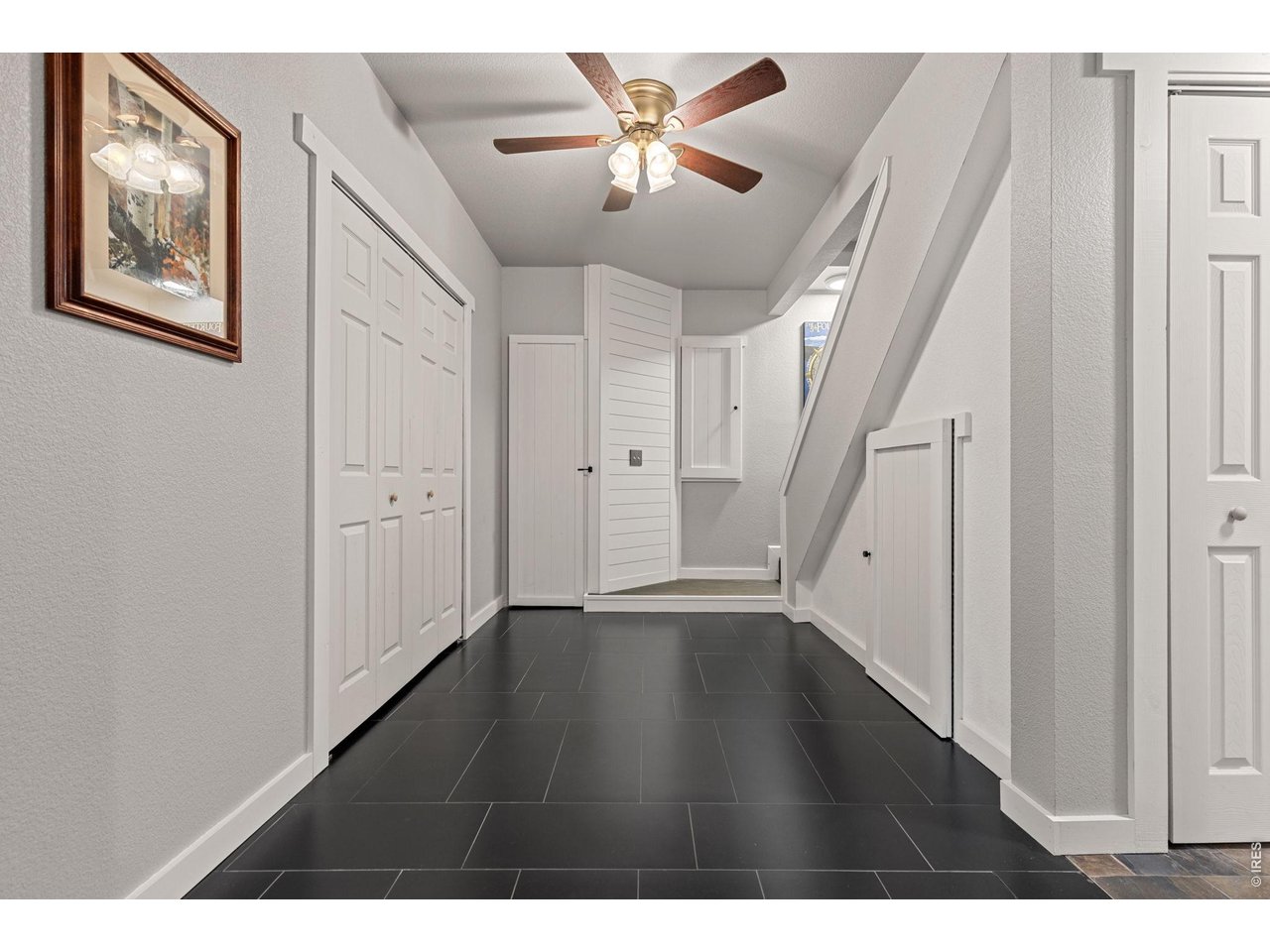 Property Photo 9 From the mudroom, transition into the home with stairs leading to the upper levels and cleverly concealed storage nearby.
