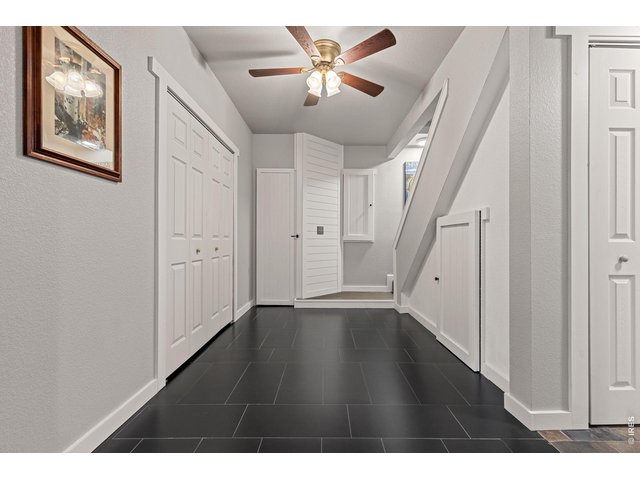 Property Photo 9 From the mudroom, transition into the home with stairs leading to the upper levels and cleverly concealed storage nearby.