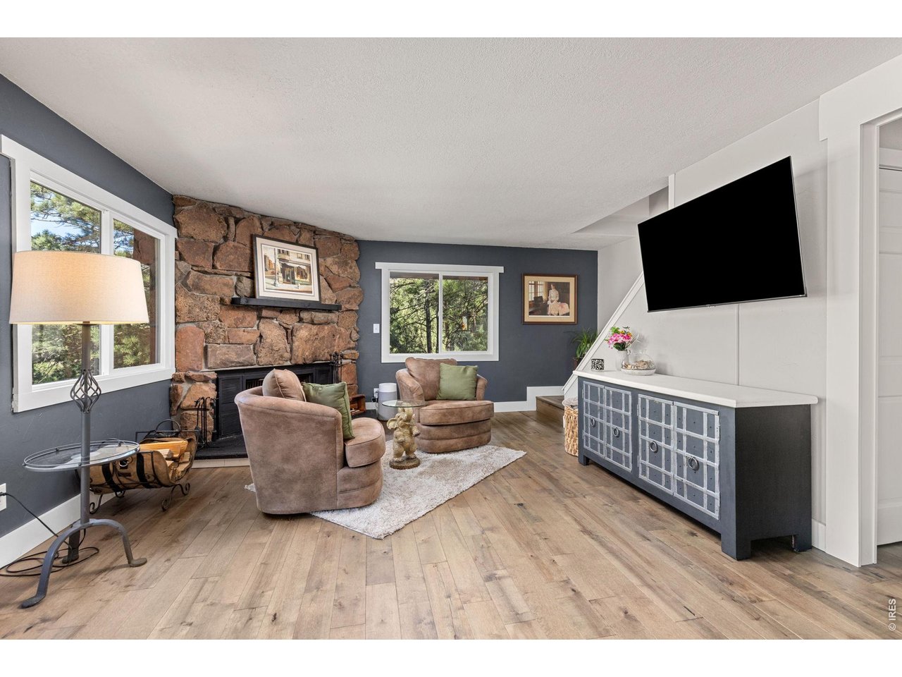 Property Photo 16 Bright, inviting living room surrounded by windows framing the canyon setting.