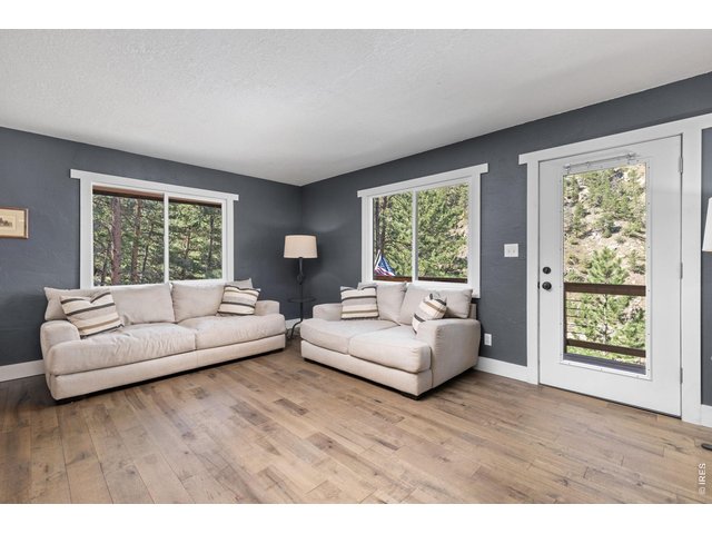 Property Photo 18 Inviting living room surrounded by windows that bring the canyon setting indoors.