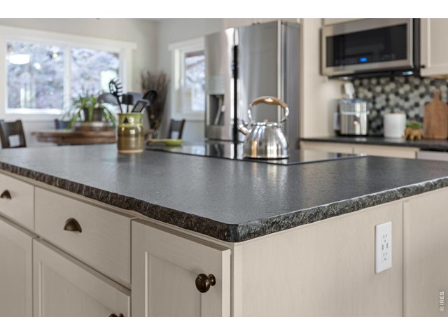 Property Photo 11 Leathered granite countertops add texture and character to the remodeled kitchen.
