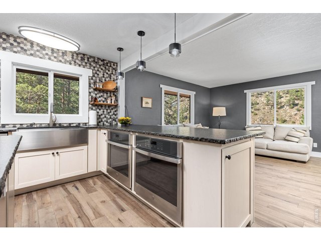 Property Photo 12 Solid maple cabinetry, stainless appliances, double wall ovens and porcelain tile backsplash.