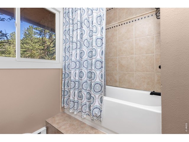Property Photo 24 Raised tub and shower complete the main-level full bathroom.