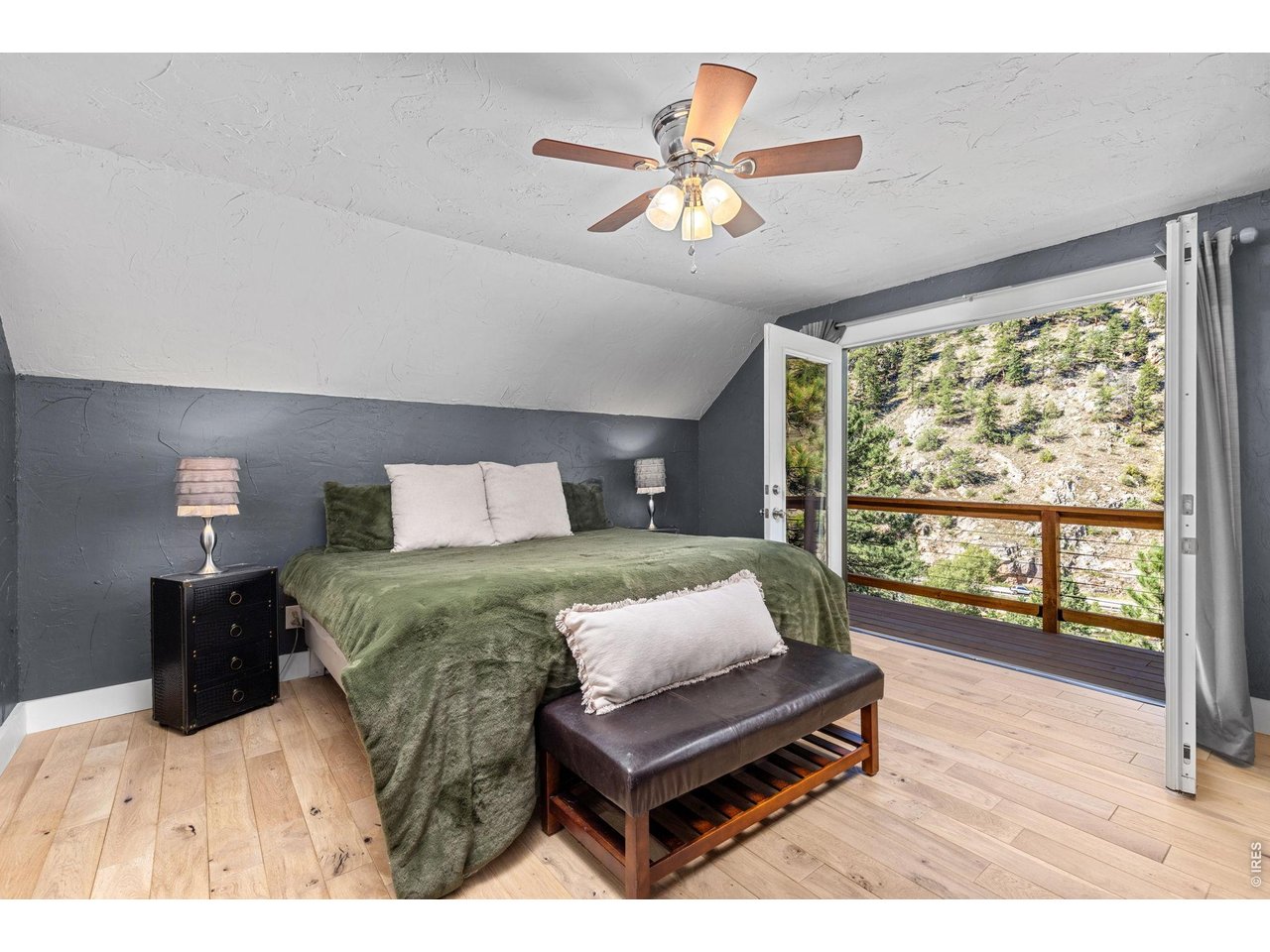 Property Photo 26 The primary bedroom opens directly to a covered balcony overlooking the canyon surroundings.