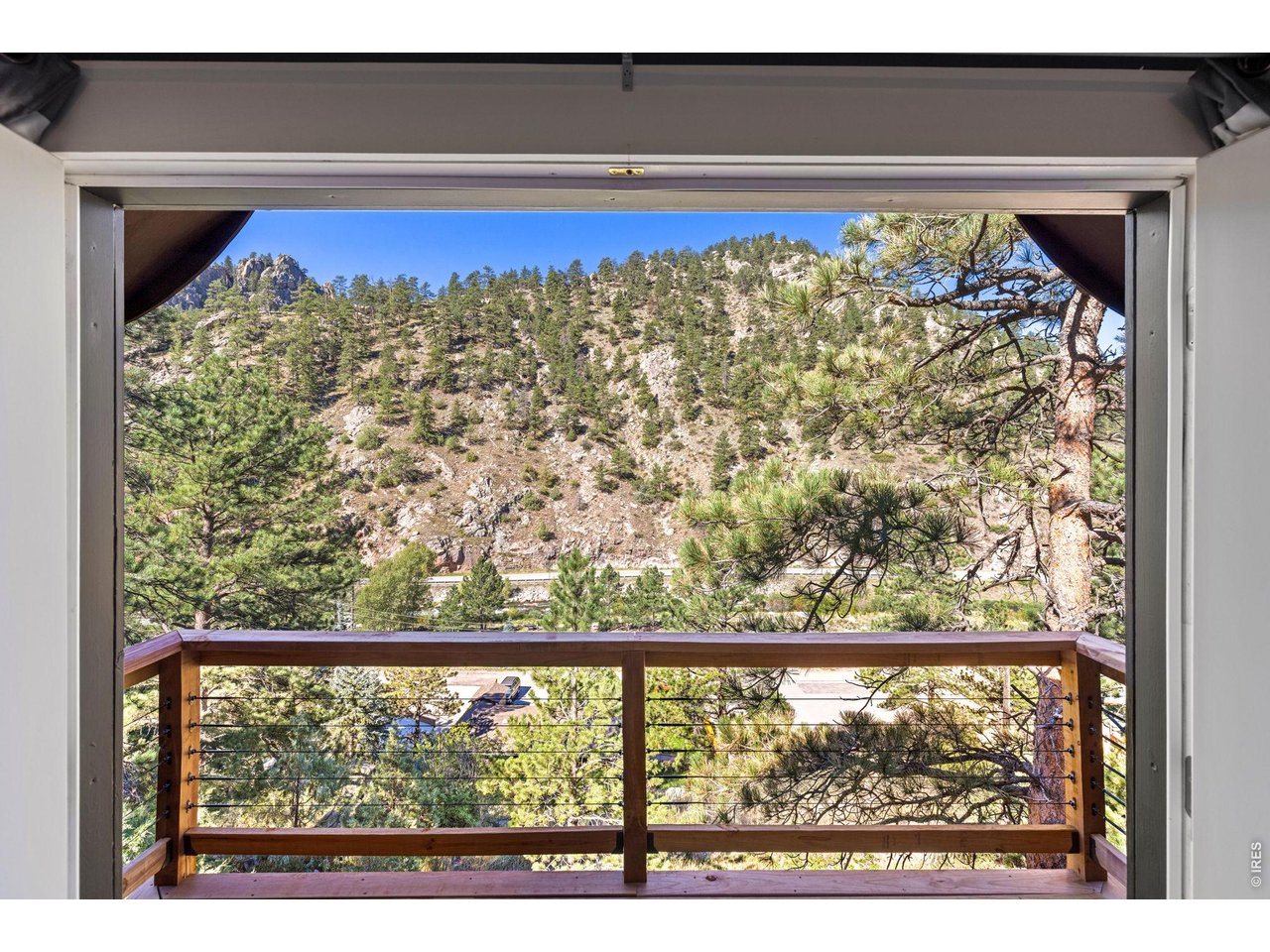 Property Photo 27 Covered balcony overlooking the forested canyon surroundings.