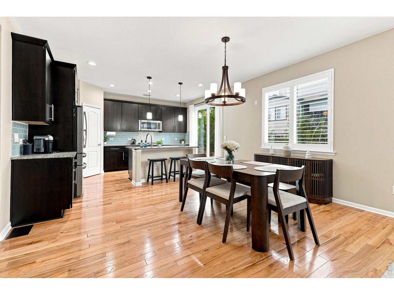 Property Photo 7 The gourmet kitchen is designed for both cooking and entertaining, featuring a gas cooktop, double ovens, upgraded refrigerator, large island, abundant cabinetry, pantry, and a comfortable eat-in area
