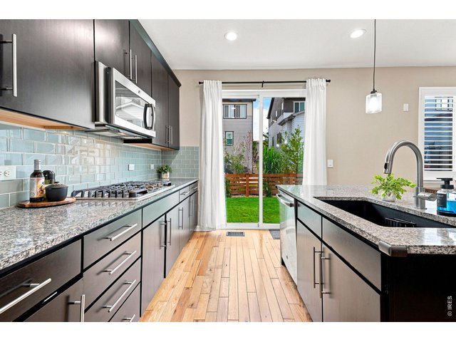 Property Photo 5 The gourmet kitchen is designed for both cooking and entertaining, featuring a gas cooktop, double ovens, upgraded refrigerator, large island, abundant cabinetry, pantry, and a comfortable eat-in area