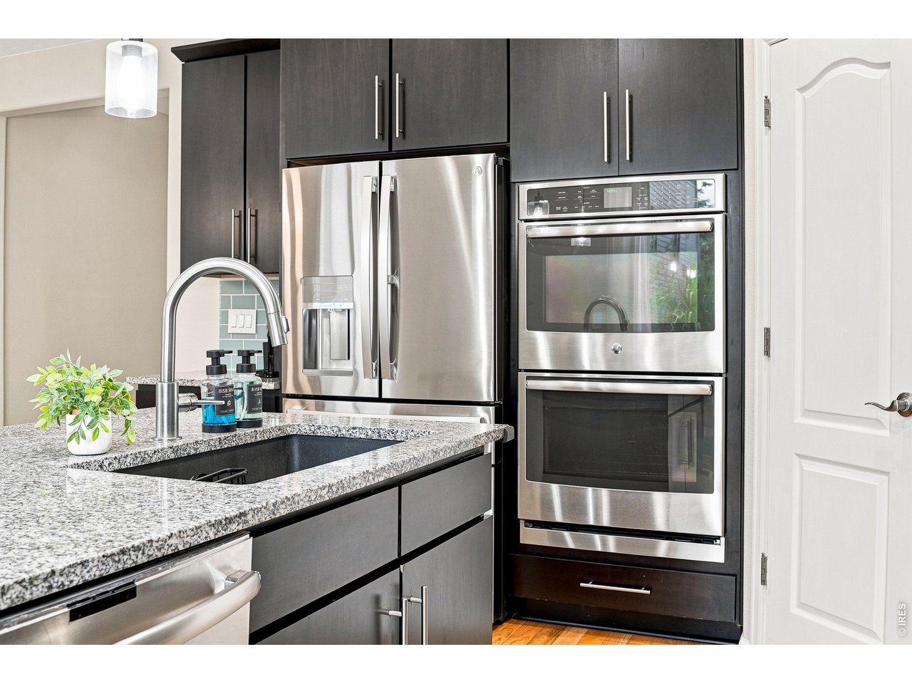 Property Photo 6 The gourmet kitchen is designed for both cooking and entertaining, featuring a gas cooktop, double ovens, upgraded refrigerator, large island, abundant cabinetry, pantry, and a comfortable eat-in area