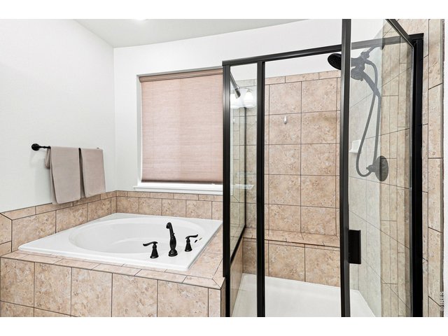 Property Photo 22 Luxurious primary suite features a custom walk-in closet and an upgraded five-piece bath, creating a relaxing retreat
