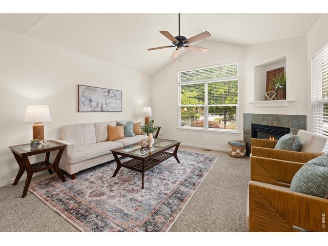 Property Photo 5 Walk into your sun filled living room with big beautiful windows and a gas fireplace.