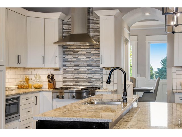 Property Photo 18 Kitchen flows well through butler's hall to pantry with expansive countertop space.