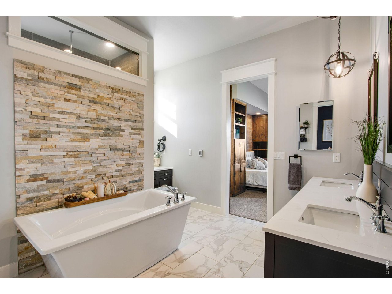 Property Photo 28 Spa like primary bathroom with stone accents and brand new heated tile floors.