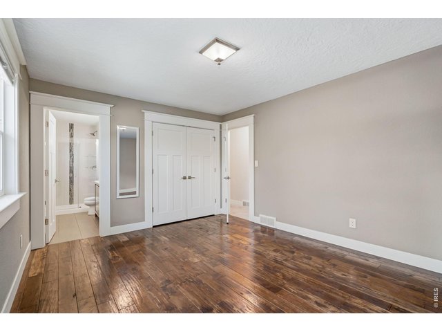Property Photo 21 Primary bedroom with engineered hardwood flooring