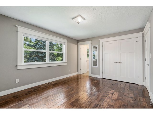Property Photo 19 Primary bedroom with engineered hardwood flooring