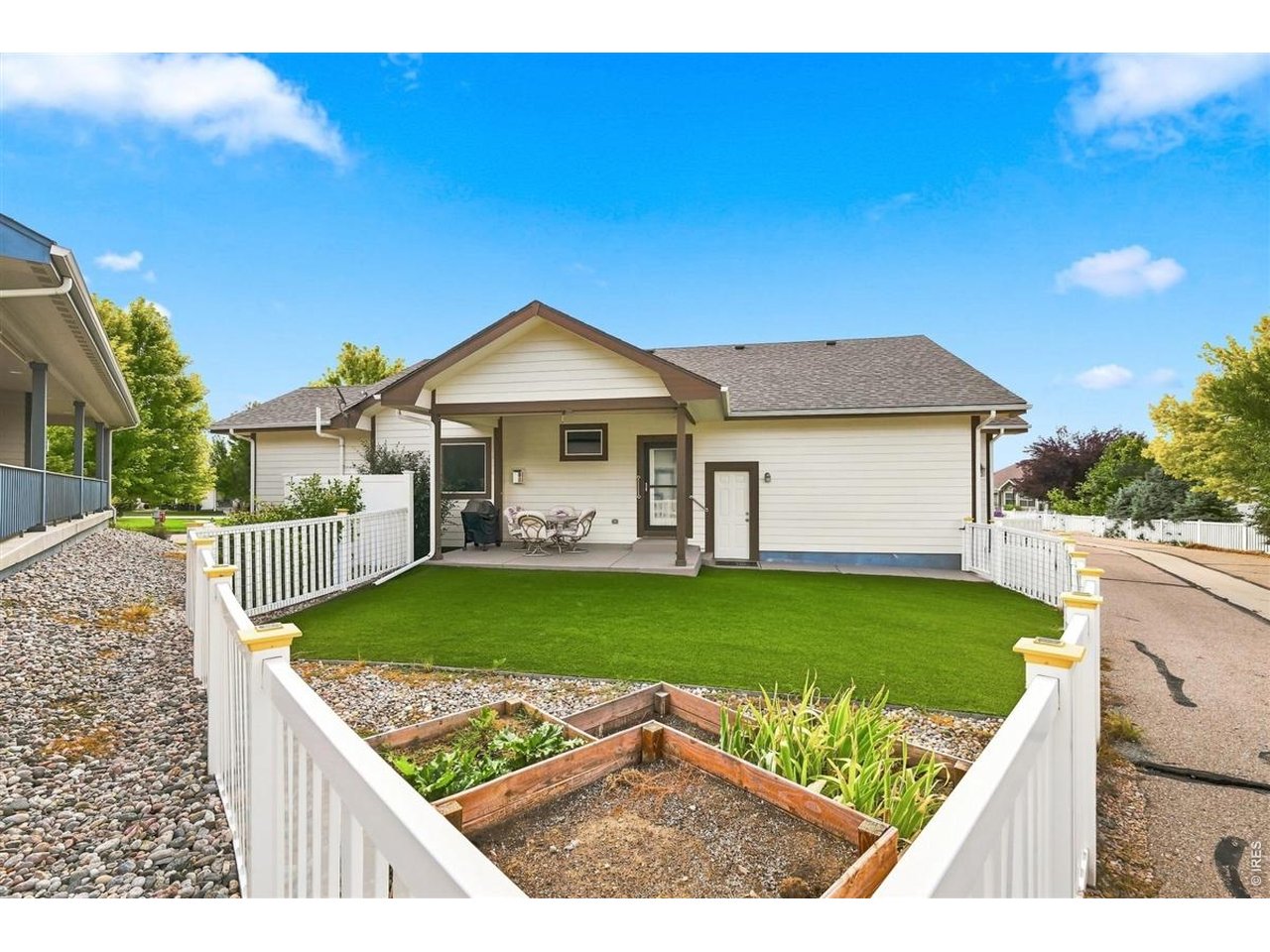 Property Photo 21 Low-maintenance turf backyard with garden boxes for those with a green thumb