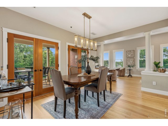 Property Photo 8 The dining room provides easy access through French doors to the large deck and park views.
