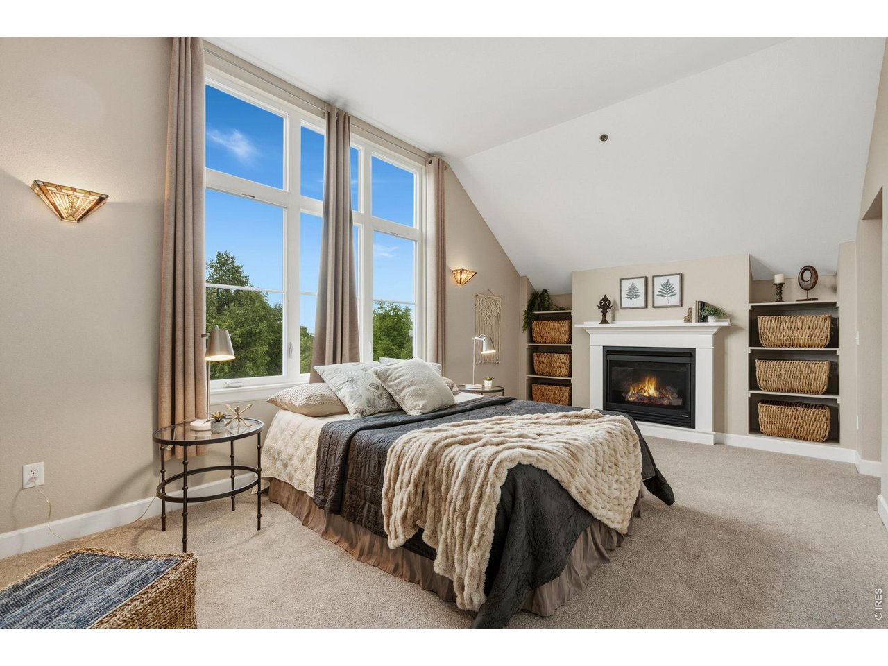 Property Photo 18 The second floor primary retreat presents vaulted ceilings and large windows with more views of the park.