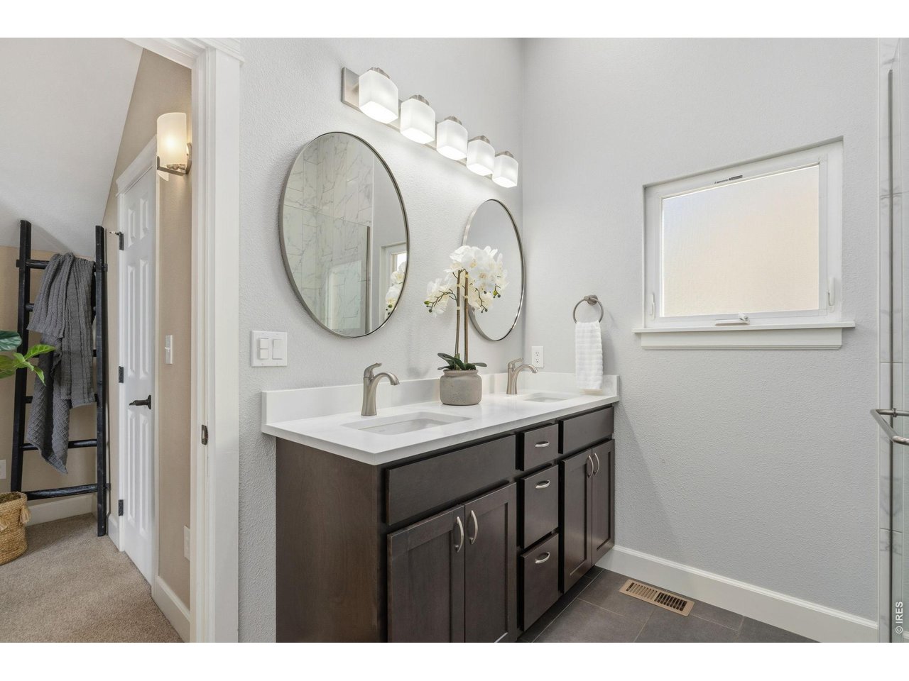 Property Photo 21 Primary bathroom provides a shower, double sink vanity and luxury finishes.