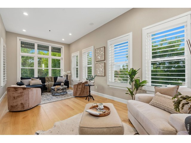 Property Photo 6 The living room boasts upgraded, engineered oak wood flooring and luxurious plantation shutters.