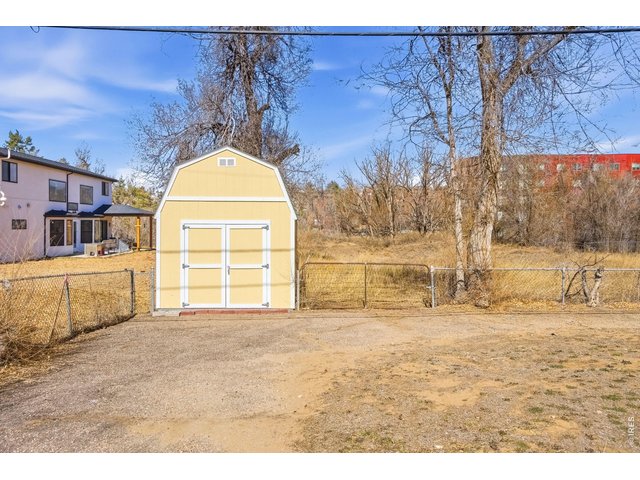 Property Photo 6 Detached Shed included! Chain link fence in place enclosing the front portion of the property making it great for your pets!