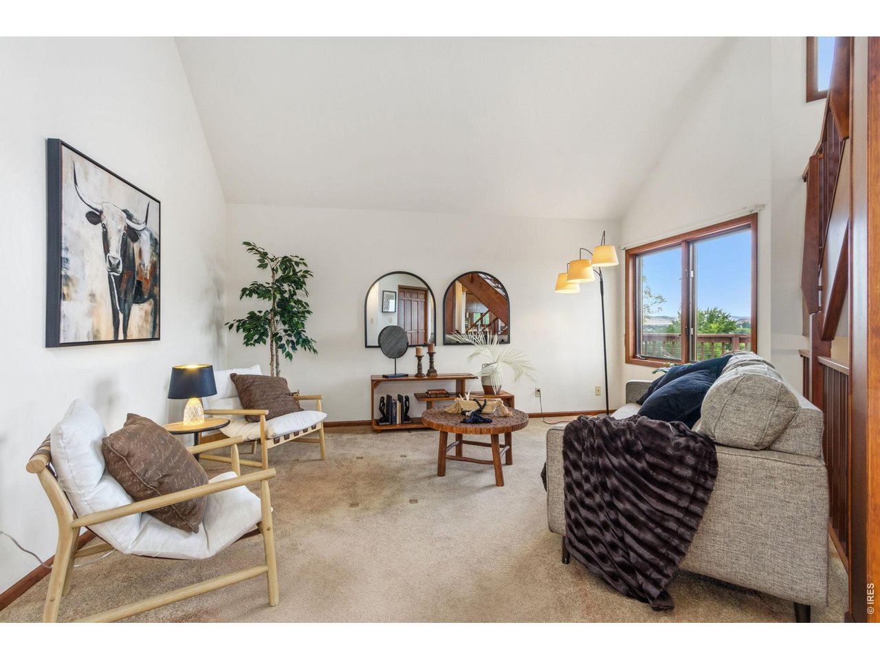 Property Photo 9 Cozy yet spacious living room featuring stunning, panoramic views of the foothills and nearby lake.