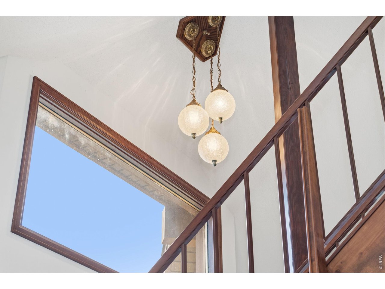 Property Photo 14 Funky and fun original lighting in stairwell, while large windows provide stunning, elevated views of the surrounding landscape.