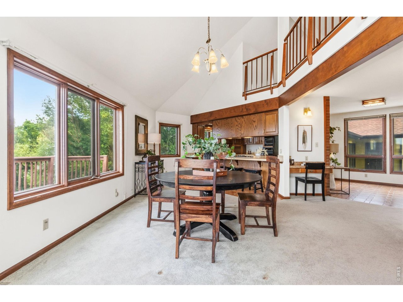 Property Photo 17 Dining room is directly adjacent to the kitchen, featuring a convenient built-in desk area to the side.