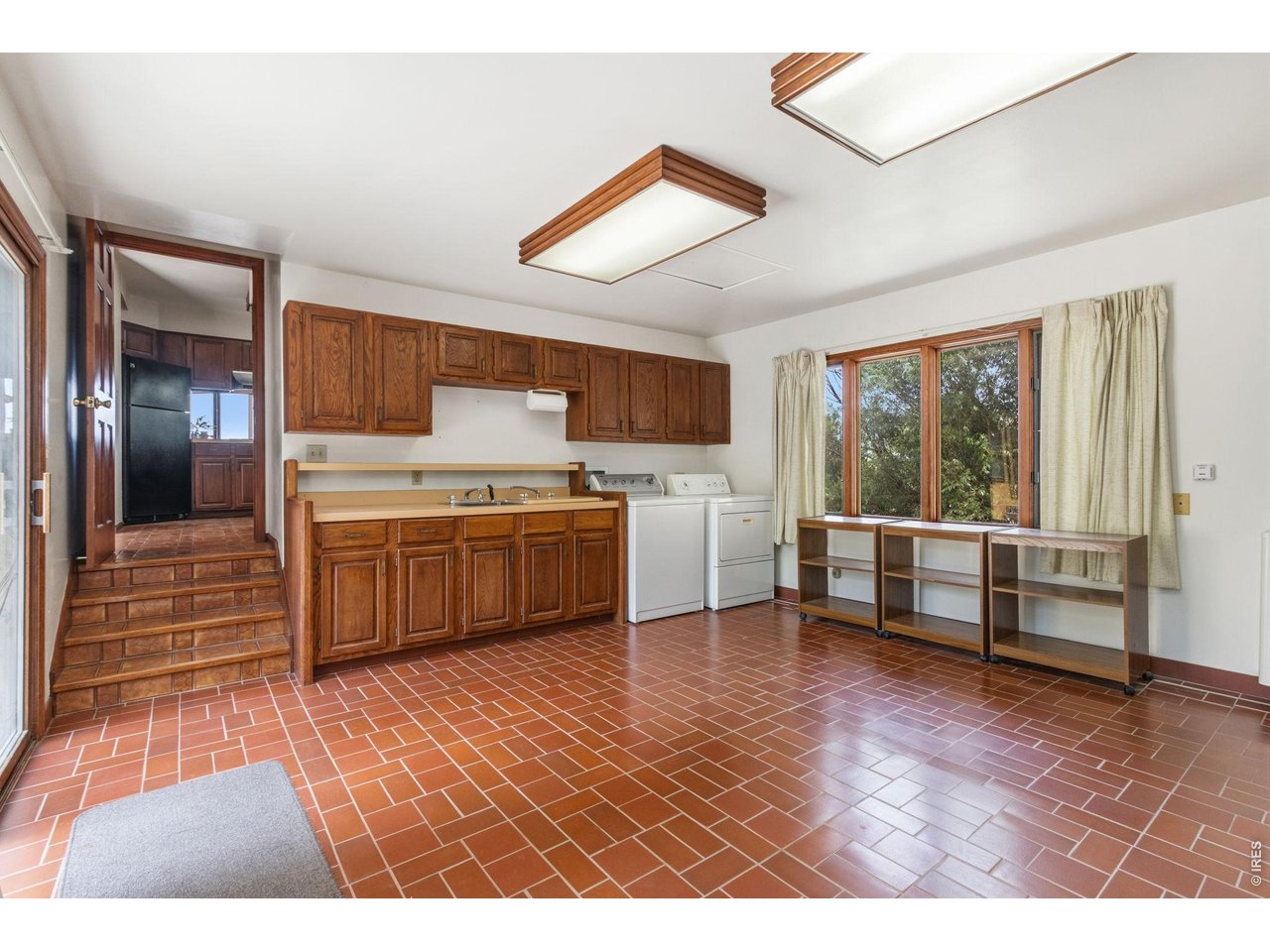 Property Photo 22 Spacious laundry/mudroom featuring dual utility sinks, ample storage space, and patio & garage access
