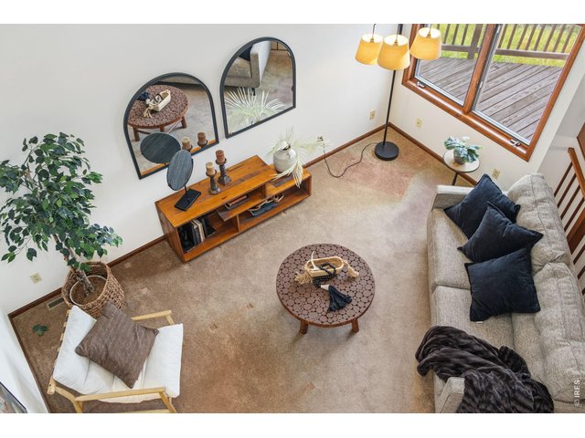 Property Photo 10 Loft view overlooking the living room, highlighting the open floor plan and soaring ceilings.