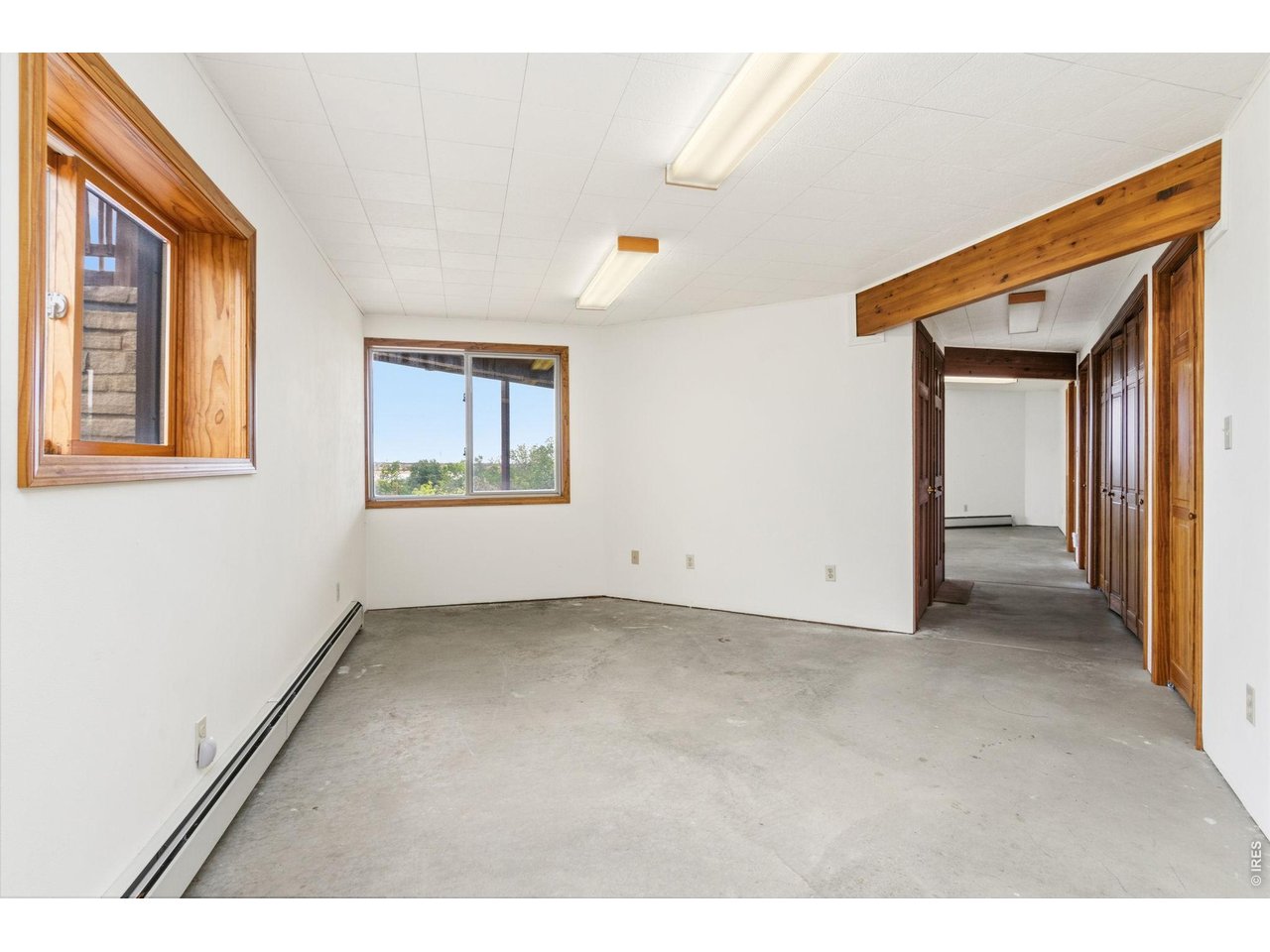 Property Photo 34 Basement west living space with lovely views. Hot water baseboard heat in basement is so comfy!