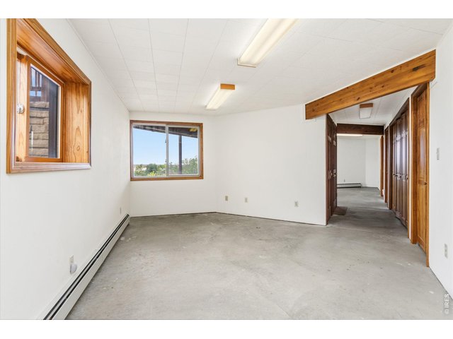 Property Photo 34 Basement west living space with lovely views. Hot water baseboard heat in basement is so comfy!