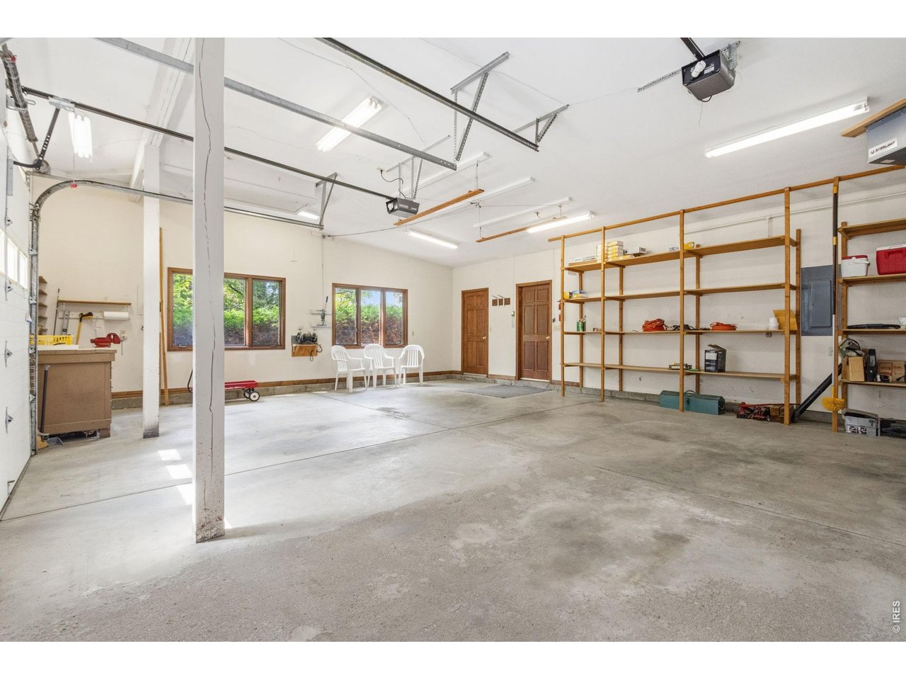 Property Photo 38 Huge garage with shelving, lots of light, front patio access, truck shell lift and room for your hobbies!