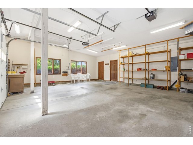 Property Photo 38 Huge garage with shelving, lots of light, front patio access, truck shell lift and room for your hobbies!