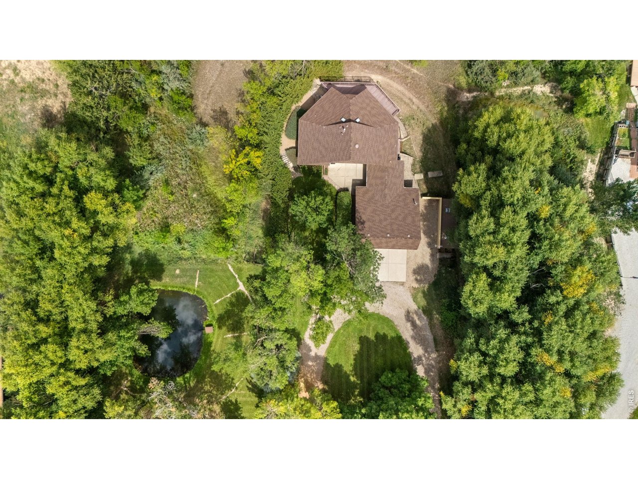 Property Photo 41 Aerial View of home, pond, trees and circular driveway