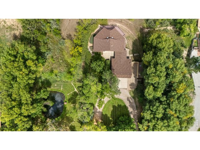 Property Photo 41 Aerial View of home, pond, trees and circular driveway