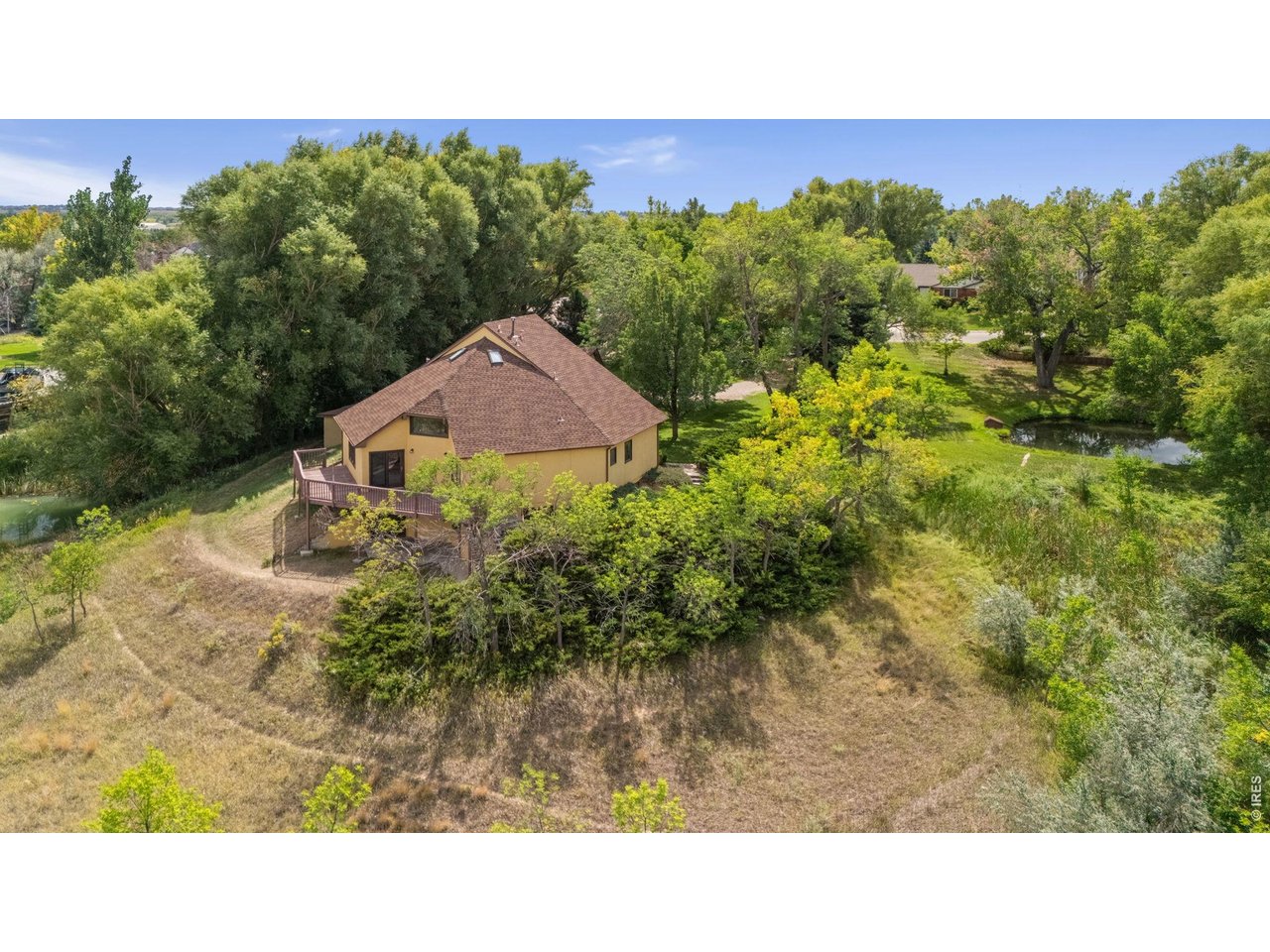 Property Photo 43 Elevated view capturing the rear of the home and the private pond.