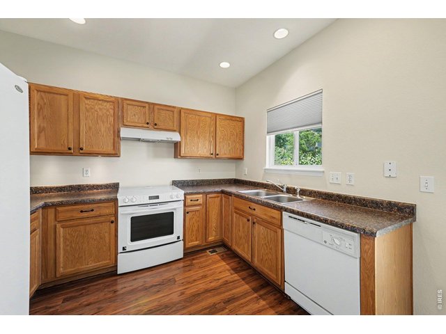 Property Photo 6 Kitchen has wood cabinets, laminate countertops, and all white appliances!