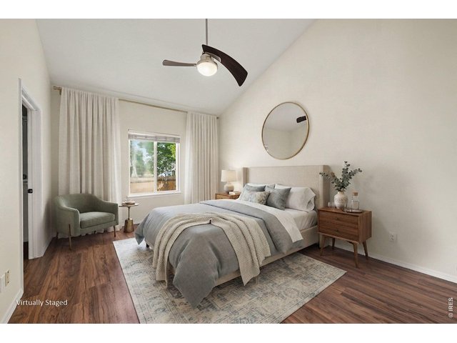 Property Photo 10 Staged primary bedroom has vaulted ceilings and a ceiling fan!