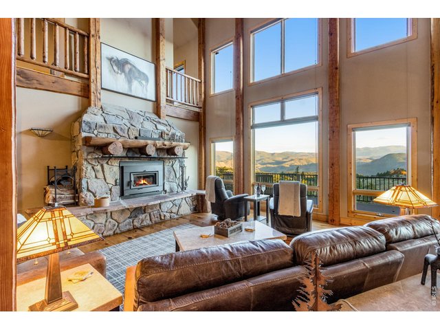 Property Photo 14 Family room with 33' high vaulted ceilings, NEW wood burning Regency fireplace, full length and flagstone hearth plus a custom log mantel