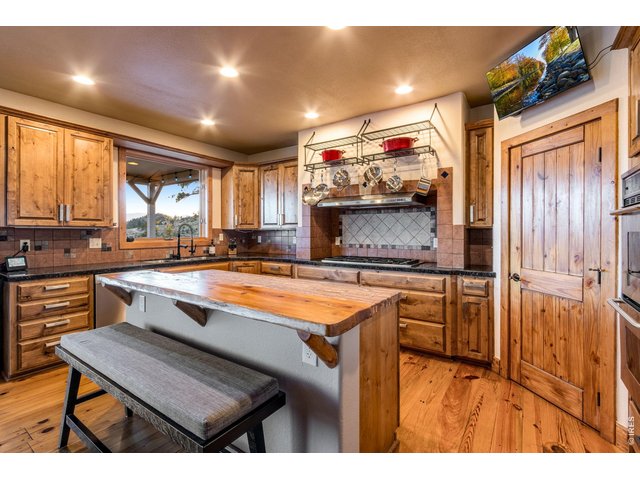 Property Photo 21 Open kitchen featuring a center island, breakfast bar, pantry with built in spice rack