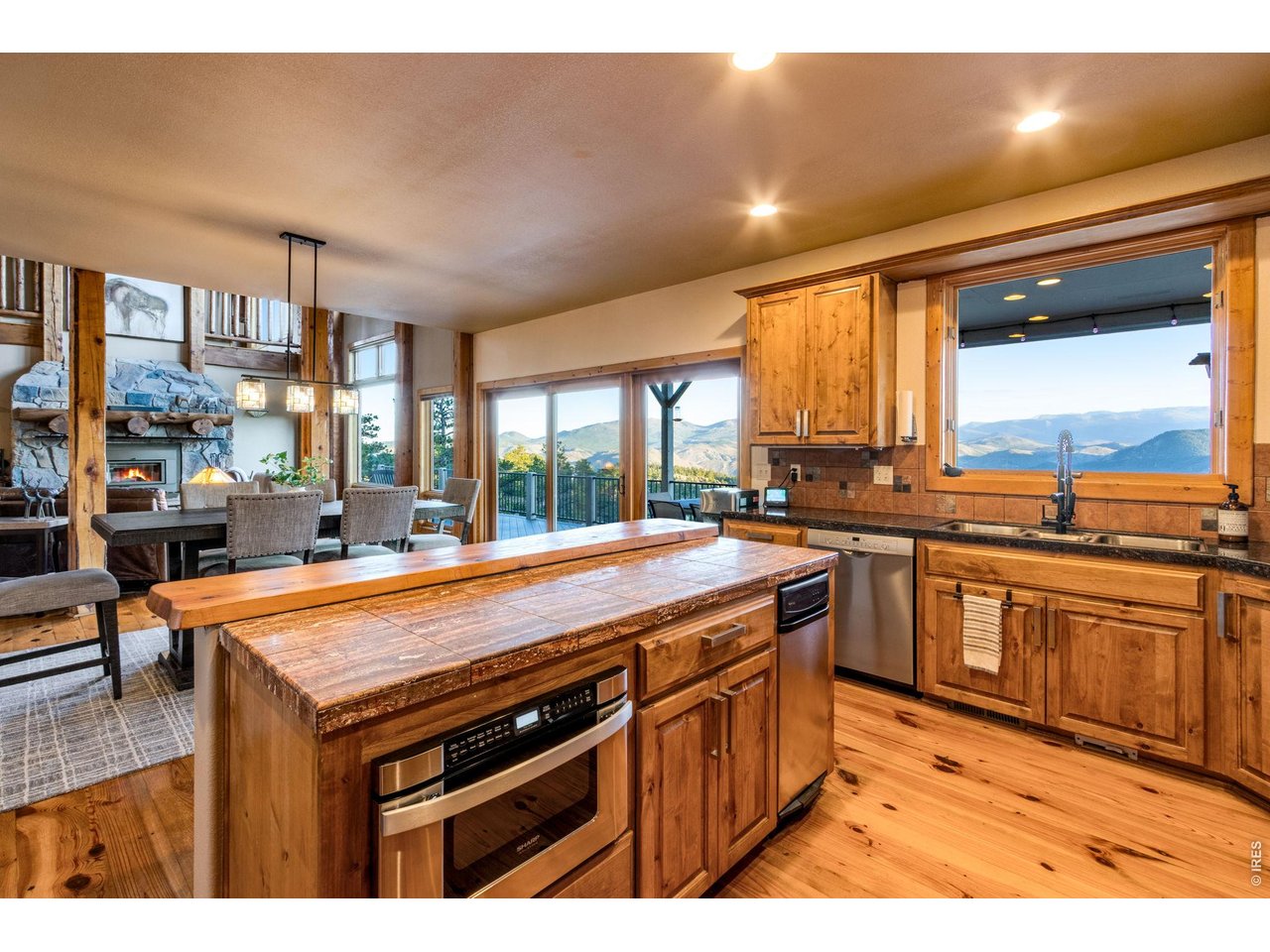 Property Photo 22 granite tile countertops, knotty alder cabinets, crown molding, hardware, Lazy Susan, undermount lighting, stainless steel appliances, double ovens, 6-burner gas range, hood system, pot rack and trash compactor