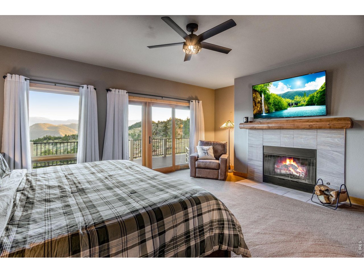 Property Photo 27 wood burning fireplace (features gas stub for conversion), wood mantel, ceiling fan, incredible views